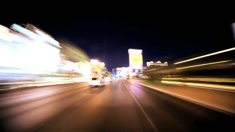 Timelapse point of view of traffic and neon lights on the streets of Las Vegas at night
