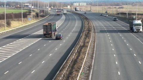 UK motorway traffic during the daytime with cars going in both directions