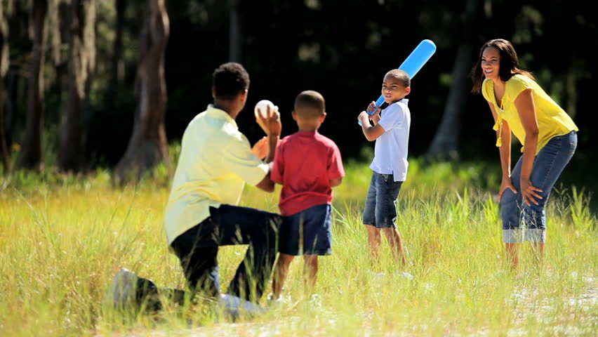 Healthy young ethnic family having fun playing baseball together in the park | Shutterstock HD Video #1919149
