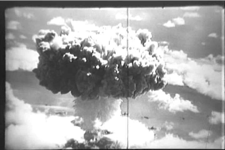 Footage shot from an airplane gives an aerial view of the mushroom cloud accompanying an atomic bomb test off the Bikini Islands in 1946. (1940s)