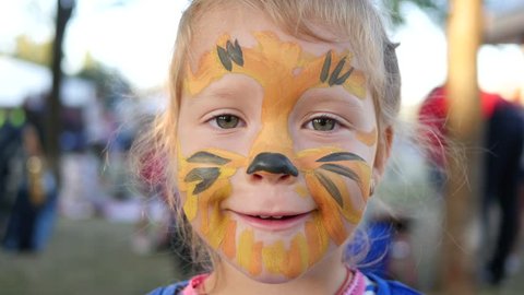Body art painting smile face of little cute child girl happy childhood portrait