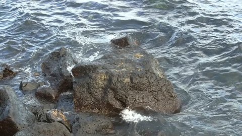 Sea waves splashing on rocks.