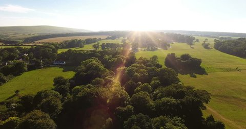 Aerial view of a beautiful countryside scene at sunset towards the coastline
