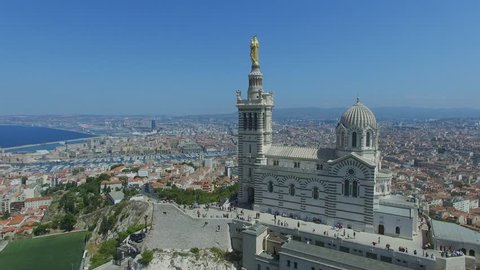 MARSEILLE, FRANCE - JUL 31, 2016: Panorama of city on sea shore and edifice of Notre Dame de la Garde at summer sunny day. Aerial view