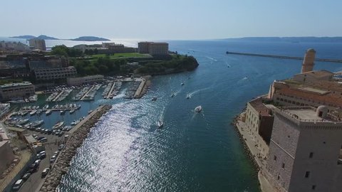 MARSEILLE, FRANCE - JUL 30, 2016: City panorama with fort Saint-Jean and vessels sail by Avant port Joliette near Old port and Parc du Pharo at summer sunny day. Aerial view