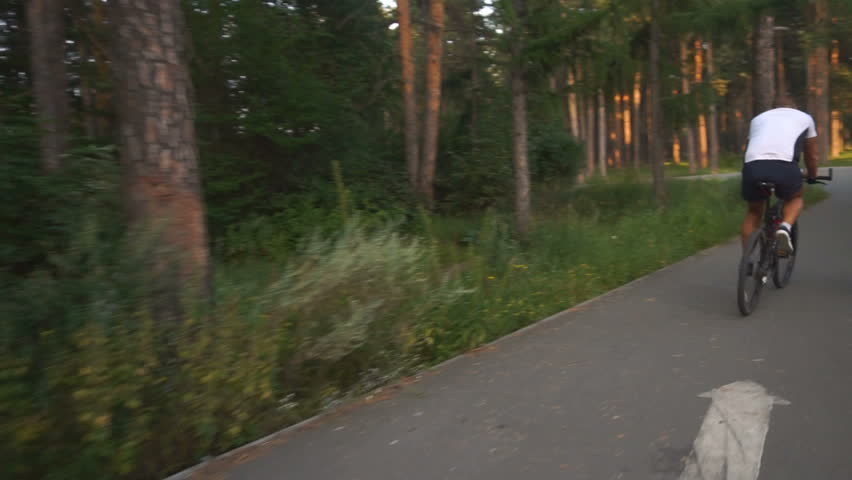 Cyclist rides in the park slow motion