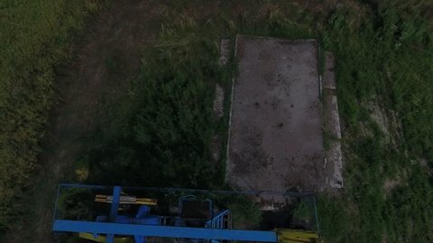 4K Aerial Shot Of A Pump Jack In The Middle Of A Green Field