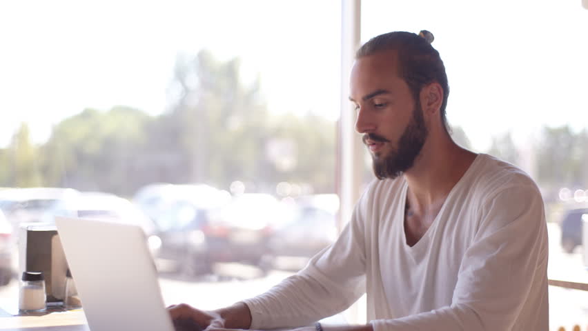 intelligent male freelancer work on notebook