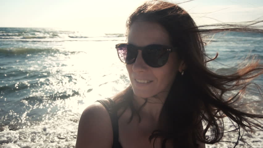 Attractive girl on the seacoast in sunglasses