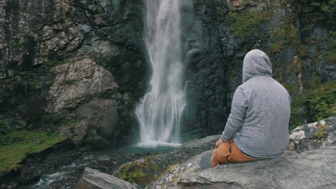 Waterfall And Young Man Stock Video