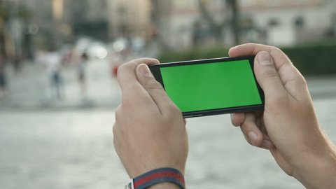 Close Up Man Holding Smartphone Touch Screen With Green Screen Chroma Key For Custom Content