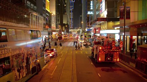 HONG KONG. CHINA - CIRCA JAN 2015: Fire truck pulls away from curb in downtown Hong Kong with emergency lights flashing. Video FullHD 1080p