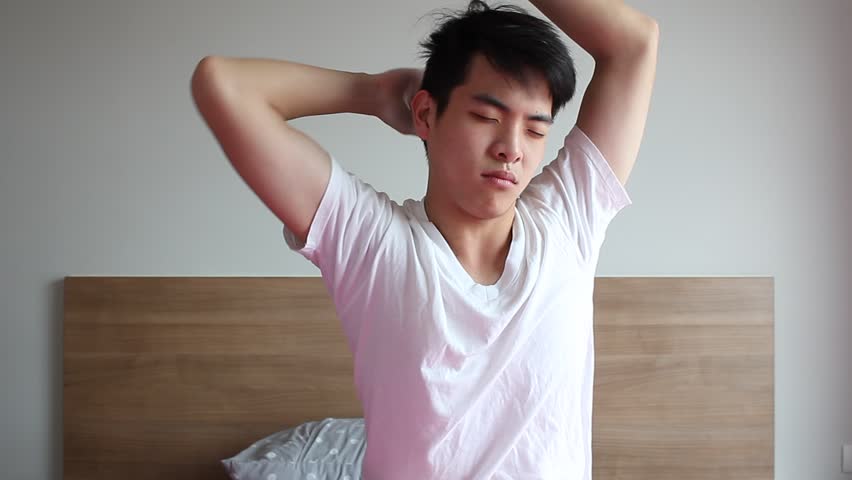 Young man wake up and stretch on bed | Shutterstock HD Video #19275769