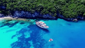 Tropical Ionian Greece Blue Lagoon island Aerial 4k travel video. Ocean sea forest coast seashore, water, yacht boat