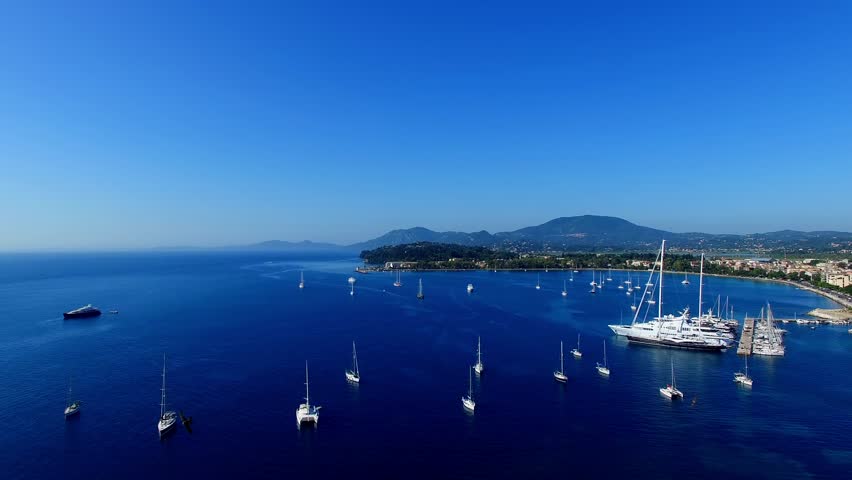 Old Fortress Marina with yachts boat ship Corfu, Greece panoramic aerial 4k video. Garitsa Bay sea ocean coast, old city