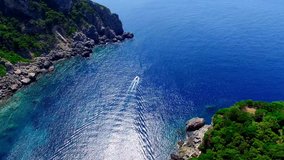 Ship boat sailing on Paleokastritsa bay Greece Corfu aerial 4k travel video. Gulf ocean sea rocky coast