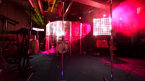 MOSCOW, RUSSIA - JANUARY 23, 2016: View of the stage with musical instruments and microphone and red fleshing lights. Famous bar "Mumiy Troll".