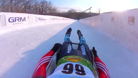 MOSCOW, RUSSIA - JANUARY 23, 2016: Tobogganer slides down the track during Luge World cup at Sparrow Hills (Vorobyovy Gory). View from the first person.