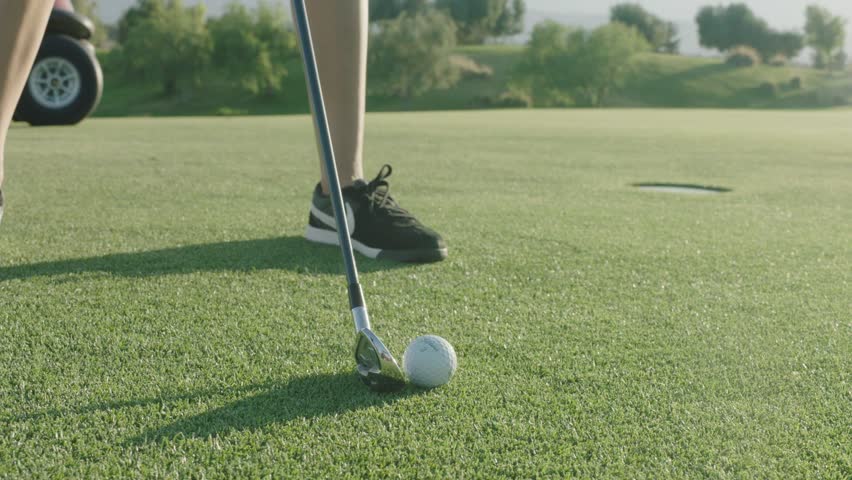 Professional golf player plays in Palm Springs at the amazing green golf course. SLOW MOTION. Shot on ARRI ALEXA. Very cinematic look | Shutterstock HD Video #19285696