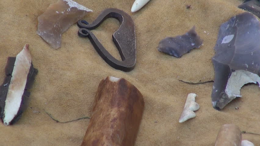 Display of various iron age tools and animal furs during medieval baltic fair on sunny summer day