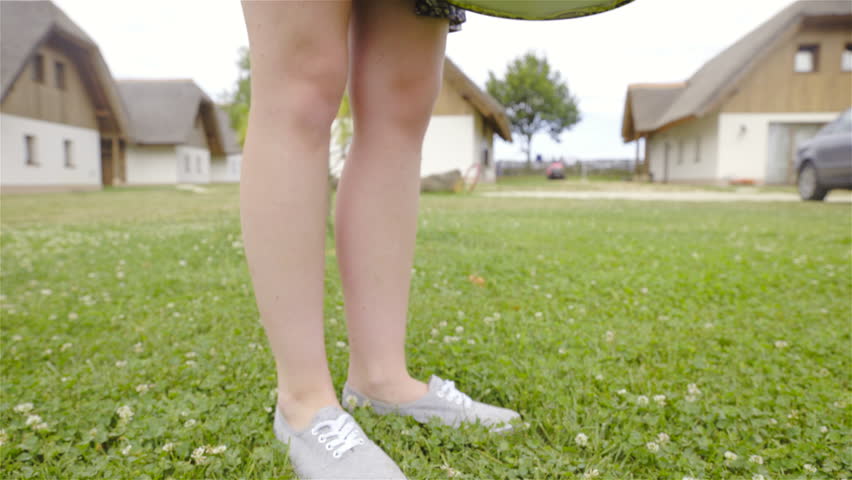 Opening picnic bucket and pulling out blanket closeup 4K. Low angle view dolly slide of person putting down stylish bucket and putting out blanket for putting over lawn.