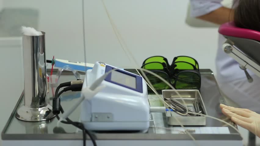 Stomatology - woman take the glases off the table