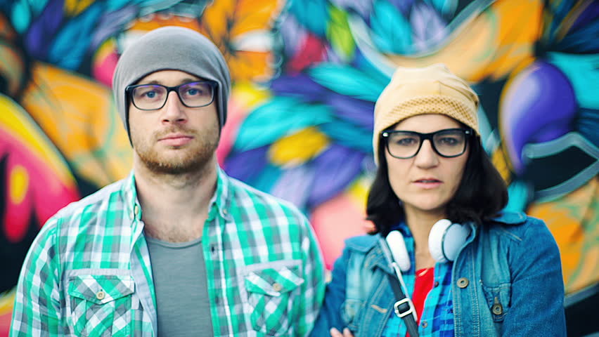 Pair of hipsters doing serious look to the camera
