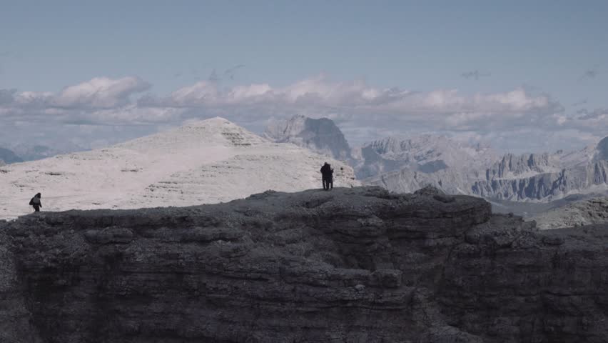 Tourists on the top of a mountain enjoying the marvelous view. 4k