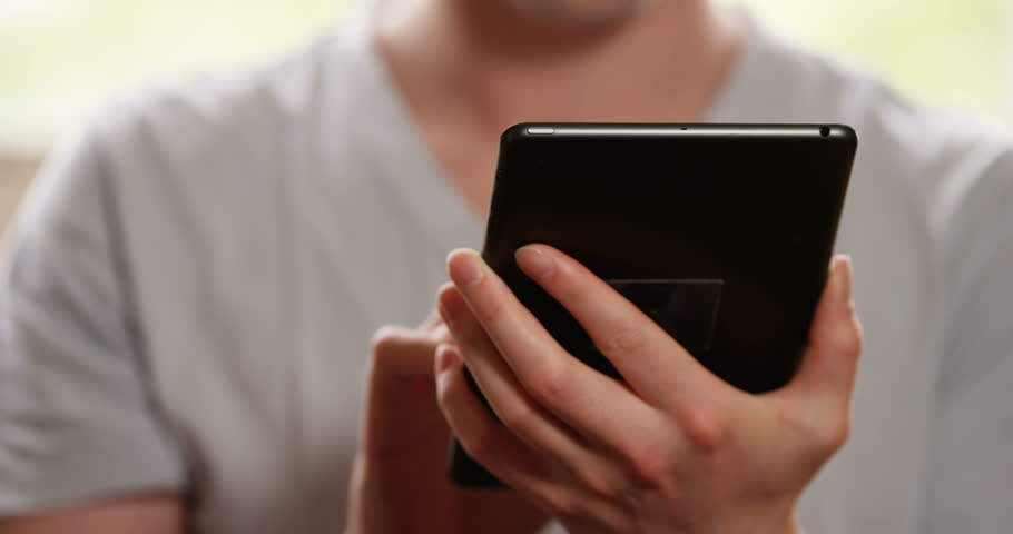 4k, Young businessman using tablet computer for online shopping. Working from home.