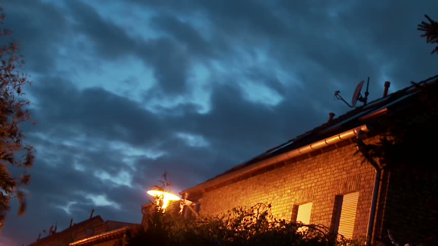 Time lapse of clouds over a house