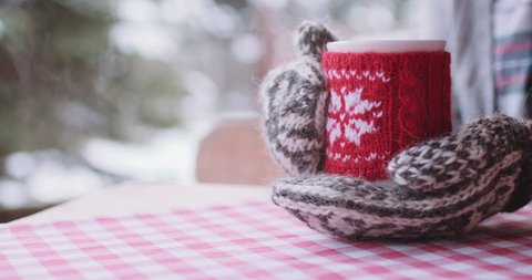 Woman Drinks Hot Tea or Coffee From Cup at Cozy Snowy House Garden on Winter Morning. 4K DCi SLOW MOTION 120 fps. Beautiful Girl Enjoying Winter Outdoors with a Mug of Warm Drink. Christmas Holidays 