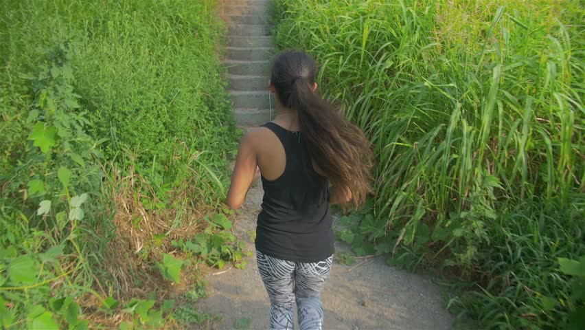 Healthy female Japanese runner up stairs beautiful river  