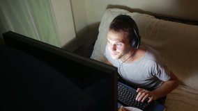 man playing video games on your computer. late at night on the computer gamer