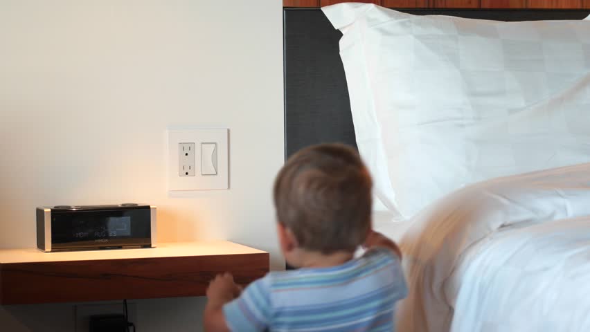 A little boy plays inside a hotel room while on vacation