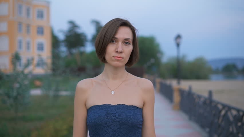 Portrait of a young, attractive woman in the street.