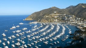 Looking down at the bay and town of Avalon on Catalina Island. Boat fill the harbor. Time Lapse.