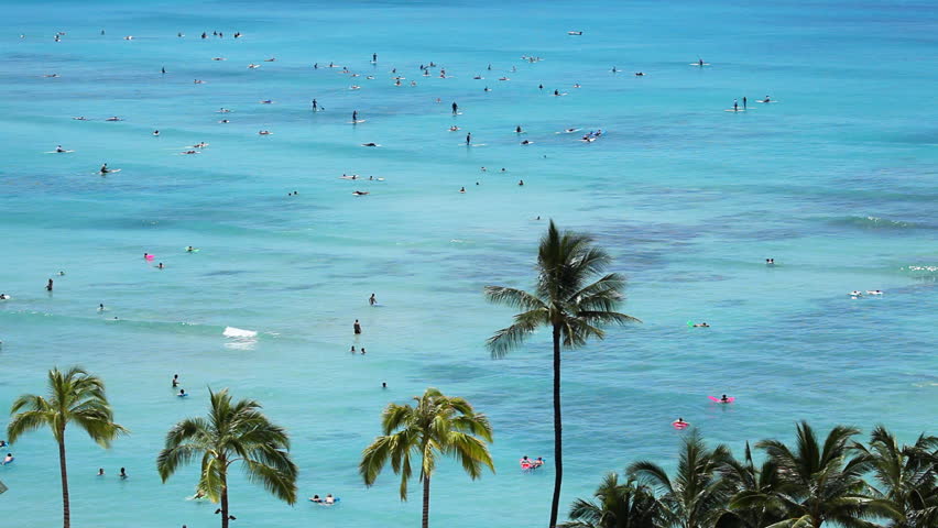 High view at the beach resort in Waikiki, Hawaii. Lots of people surfing,