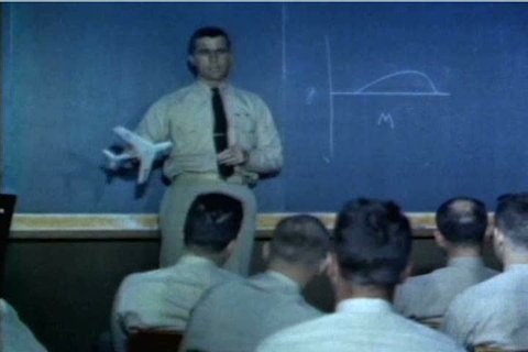 After a morning class on engineering, students at the US Naval Test Pilot School check a giant schedule which tells them who is running a test pilot when, in 1959. (1950s)