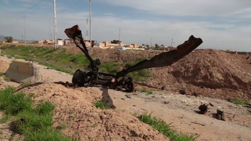 Exploded and bent, damaged remains of a truck that was bombed