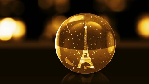 Eiffel Tower in golden glass ball with snow