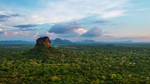 Sunset over the Lion Rock in Sigiriya, Sri Lanka. Aerial view of the tropical forest with mountains. Time-lapse