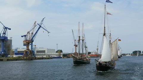 WARNEMUENDE, Mecklenburg-Vorpommern/ GERMANY AUGUST 13 2016: historical sailing boats and schooner sailing along the Rostock Harbor at Warnemuende during Hanse Sail weekend event.