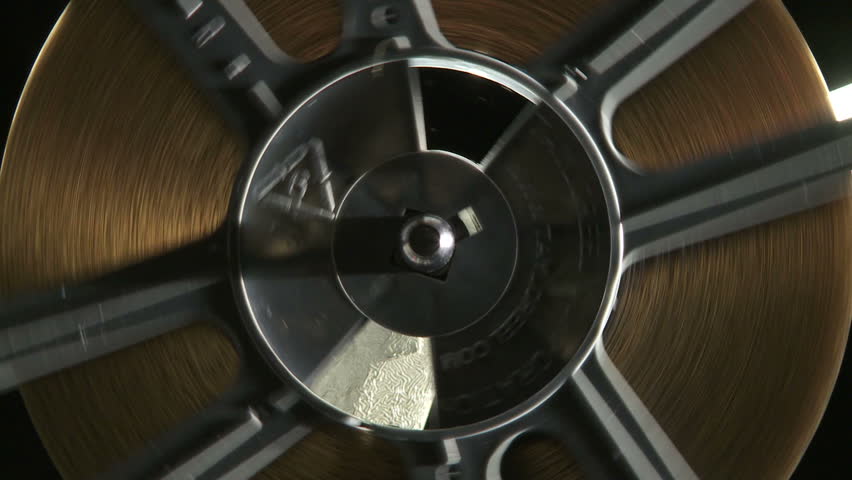 Close up of rotating 16mm film reel on projector
