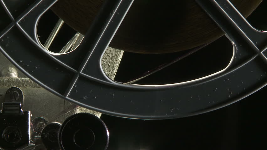 Close up of rotating 16mm film feed reel on projector