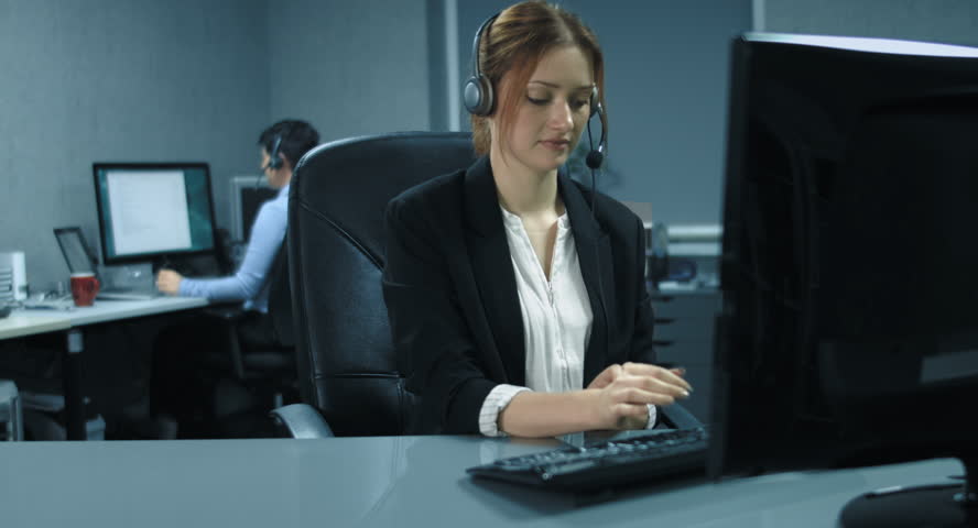 4K: Two female callcenter agents are working at her computer with a Headset. They are really friendly and helpful to the clients.
 Royalty-Free Stock Footage #19412074