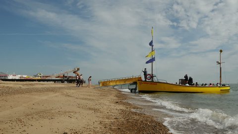 Great Yarmouth, England - August 2016. Tourist boat full of tourists on the beach at Great Yarmouth, Norfolk, England, United Kingdom