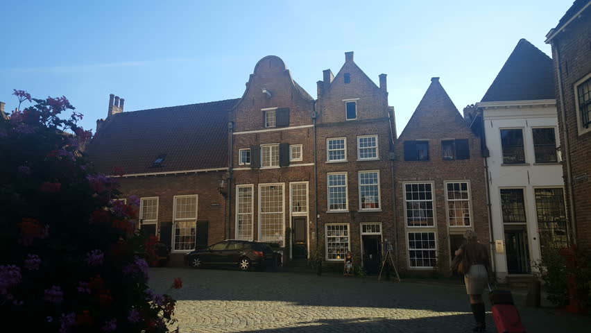 Tourist with suitcase in alley in Deventer