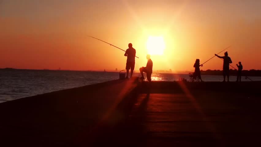 People fishing in sunset