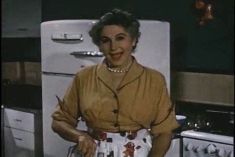 A woman shows off the frozen fruit she uses to make jelly in 1951. (1950s)
