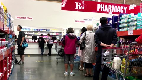 Port Coquitlam, BC, Canada - September 07, 2016 : People line up for waiting to pick up their medicine inside Costco pharmacy